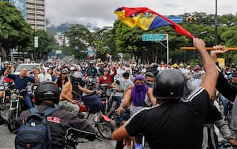 epa11507581 People ride through the streets on motorcycles during a protest against the results of the presidential elections, in Caracas, Venezuela, 29 July 2024. According to the first report from the National Electoral Council (CNE), Maduro was re-elected for a third consecutive term in the elections held on 28 July, in which he obtained 51.2 percent of the votes (5,150,092 votes), while the standard-bearer of the majority opposition, Edmundo Gonzalez Urrutia, obtained 4,445,978 votes, which represents 44.2 percent of the votes. The opposition is calling for the release of the full vote count.  EPA/Henry Chirinos