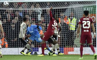 epa10182465 Joel Matip (C) of Liverpool scores the 2-1 lead against goalkepeer Remko Pasveer (C-L) of Ajax during the UEFA Champions League group A soccer match between Liverpool FC and Ajax Amsterdam in Liverpool, Britain, 13 September 2022.  EPA/PETER POWELL