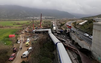 epa10496492 Rescuers at the scene of a train collision, near Larissa city, Greece, 01 March 2023. The number of confirmed dead from the deadly train collision at Tempi rises to 36 on Wednesday 01 March morning as the search-and-rescue operation continues, according to the latest update from the fire brigade spokesperson Vasilis Vathrakogiannis. The number of injured in hospital increased to 66, of which six were admitted to ICUs. The search of the wreckage is ongoing, with efforts focused on the first three carriages of the passenger train which overturned, with the assistance of specialised truck-mounted cranes.  EPA/ACHILLEAS CHIRAS