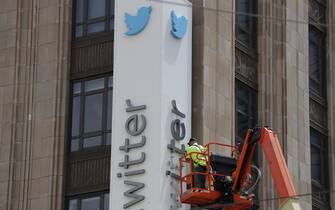 epa10766831 Workers remove letters from the iconic vertical Twitter sign at the company’s headquarters after Twitter owner Elon Musk annouced the rebranding of the social media platorm to X in San Francisco, California, USA, 24 July 2023. Work was halted due to San Francisco police responding to a call from building security that the signs were being stolen. A San Francisco police spokesperson stated that Twitter had a work order to take the sign down but didn’t communicate that to security and the property owner of the building.  EPA/JOHN G. MABANGLO