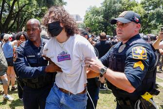 epa11309317 A student gets arrested by Austin police officers at a Protect Palestine Rally on the University of Texas at Austin campus in Austin, Texas, USA, 29 April 2024. Campus police officers from the University of Texas at Austin and state troopers in riot gear arrested dozens of pro-Palestinian protesters who had erected a small number of tents on a central mall of the university. More than 34,000 Palestinians and over 1,450 Israelis have been killed, according to the Palestinian Health Ministry and the Israel Defense Forces (IDF), since Hamas militants launched an attack against Israel from the Gaza Strip on 07 October 2023, and the Israeli operations in Gaza and the West Bank which followed it.  EPA/ADAM DAVIS