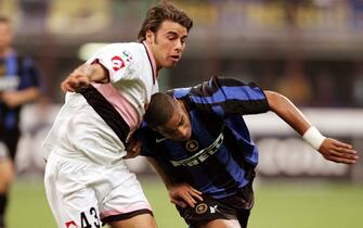 epa000277900 epa000277896 Brazilian Inter's Adriano (R) fights for the ball  against Palermo's Andrea Barzagli, during their serie A soccer match in Milan, Saturday 18 September  2004 .  EPA/MATTEO BAZZI