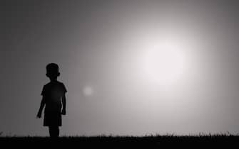 Little child walking in a field.