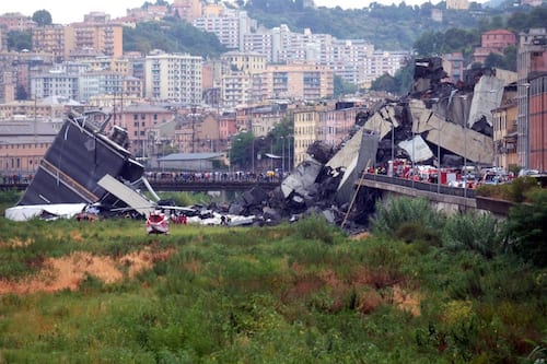 TOPSHOT - A picture taken on August 14, 2018 in Genoa shows a section of the Morandi motorway bridge that collapsed earlier injuring several people. - Rescuers scouring through the wreckage after part of a viaduct of the A10 freeway collapsed said there were "tens of victims", while images from the scene showed an entire carriageway plunged on to railway lines below. (Photo by Andrea LEONI / AFP) (Photo by ANDREA LEONI/AFP via Getty Images)