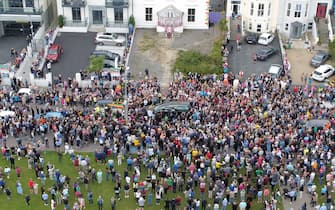 Fans of singer Sinead O'Connor line the streets for a "last goodbye" to the Irish singer as her funeral cortege passes through her former hometown of Bray, Co Wicklow, ahead of a private burial service. Picture date: Tuesday August 8, 2023.