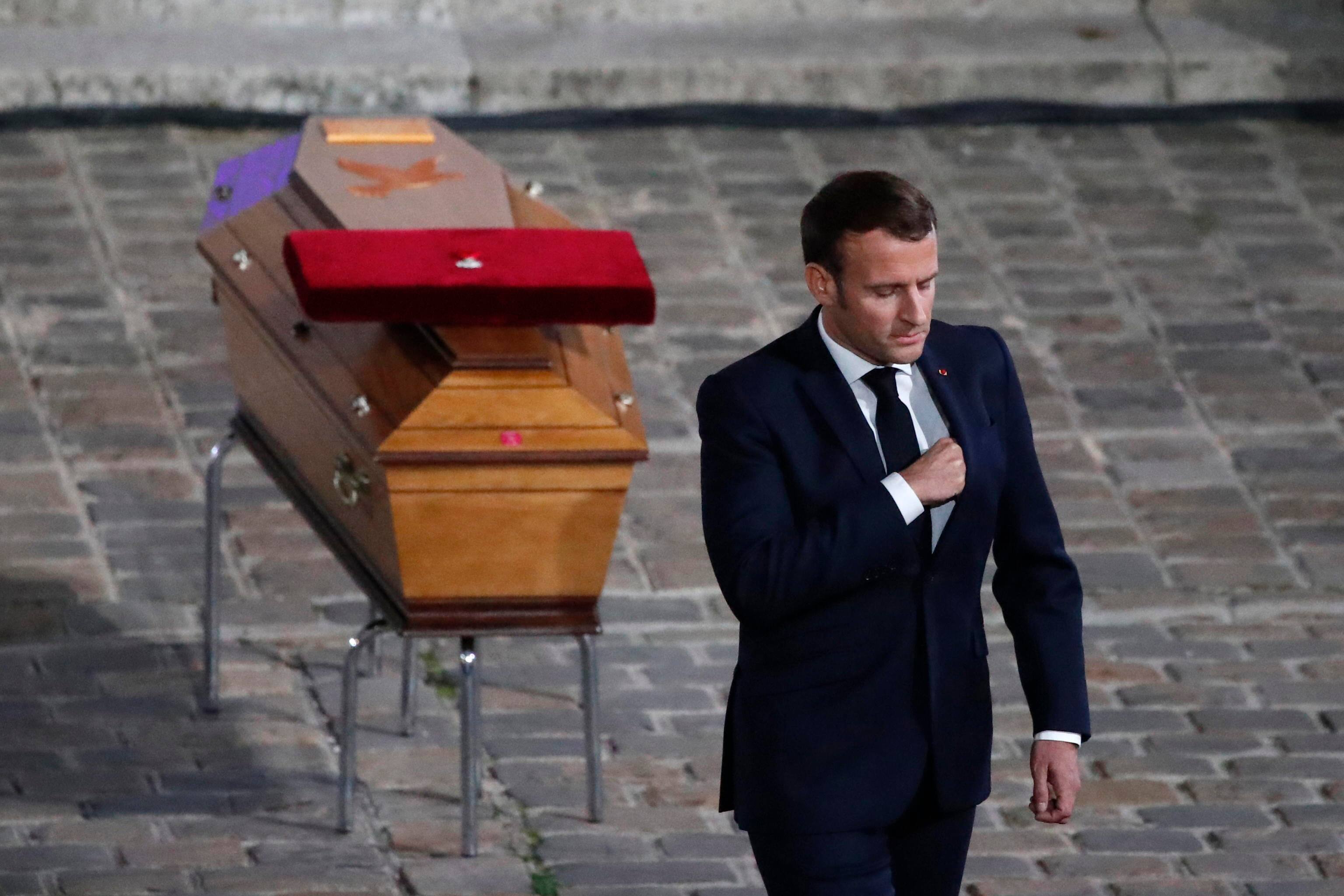 epa08762799 French President Emmanuel Macron leaves after paying his respects by the coffin of slain teacher Samuel Paty in the courtyard of the Sorbonne university during a national memorial event, in Paris, France, 21 October 2020. French history teacher Samuel Paty was beheaded in Conflans-Sainte-Honorine, northwest of Paris, by a 18-year-old Moscow-born Chechen refugee, who was later shot dead by police.  EPA/Francois Mori / POOL MAXPPP OUT