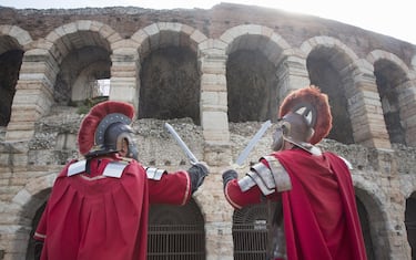 Verona coliseum with two funny romans posing for tourists.