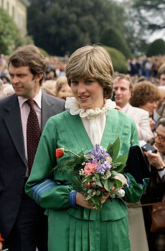 ROMSEY, UNITED KINGDOM - MAY 09:  Lady Diana Spencer (later To Become Princess Diana) On A Walkabout At Broadlands, The Former Home Of Earl Mountbatten, During Her Engagement. The Frilly Collar, A Distinctive Pie Frill Shape, Was A Favourite At That Time.  Behind Her At Left Is Her Police Bodyguard Graham Smith  (Photo by Tim Graham Photo Library via Getty Images)