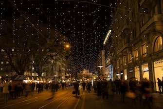 Zurich / ZÃ¼rich's famous Bahnhofstrasse with christmas lights, christmas market and Mainstation.