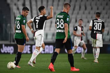 Juventus' Portuguese forward Cristiano Ronaldo (C) celebrates after scoring his second penalty during the Italian Serie A football match Juventus Turin vs Atalanta Bergamo played behind closed doors on July 11, 2020 at the Juventus stadium in Turin, as the country eases its lockdown aimed at curbing the spread of the COVID-19 infection, caused by the novel coronavirus. (Photo by Marco BERTORELLO / AFP) (Photo by MARCO BERTORELLO/AFP via Getty Images)