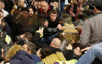 PARIS, FRANCE - FEBRUARY 24: 
French Farmers clash with members of the French police as they protest inside the Porte de Versailles exhibition centre on the day of French President Emmanuel Macron's visit to the International Agriculture Fair (Salon International de l'Agriculture) during its inauguration on February 24, 2024 in Paris, France. Several dozen demonstrators entered the Salon without authorization on Saturday morning to try to meet the Head of State after several weeks of mobilizations by part of the agricultural world. (Photo by Chesnot/Getty Images)