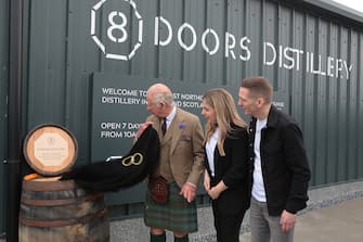 WICK, SCOTLAND - AUGUST 2: King Charles III unveils a plaque during a visit to the 8 Doors Distillery in John O'Groats, Wick, in the Scottish Highlands, to officially open the distillery and meet members of the local business community on August 2, 2023 in Wick, Scotland. (Photo by Robert MacDonald - Pool/Getty Images)