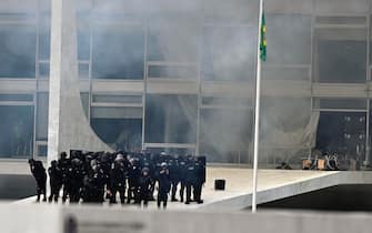 epa10396370 Riot police officers at the Planalto presidential palace, the seat of the Brazilian Government stormed by Bolsonaro supporters in Brasilia, Brazil, 08 January 2023. Hundreds of supporters of former Brazilian President Jair Bolsonaro invaded the headquarters of the National Congress, and also Supreme Court and the Planalto Palace, seat of the Presidency of the Republic, in a demonstration calling for a military intervention to overthrow President Luiz Inacio Lula da Silva. The crowd broke through the cordons of security forces and forced their way to the roof of the buildings of the Chamber of Deputies and the Senate, and some entered inside the legislative headquarters.  EPA/ANDRE BORGES