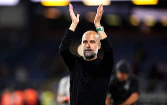 Manchester City manager Pep Guardiola applauds the fans after the final whistle in the Premier League match at Turf Moor, Burnley. Picture date: Friday August 11, 2023.