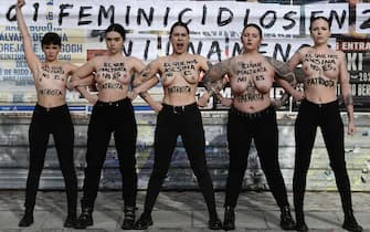 epa11107850 Members of the feminist activist group 'Femen' show the motto 'Who mistreats is not a patriot' and 'who murders us is not a patriot' on their nude torsos as they protest to denounce violence against women, in downtown Madrid, Spain, 27 January 2024.  EPA/VICTOR LERENA