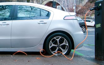 Electric car, parked and charging a battery