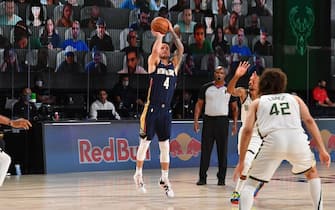 Orlando, FL - JULY 27: JJ Redick #4 of the New Orleans Pelicans shoots a three point basket during the game against the Milwaukee Bucks during a scrimmage on July 27, 2020 at The Arena at ESPN Wide World of Sports in Orlando, Florida. NOTE TO USER: User expressly acknowledges and agrees that, by downloading and/or using this Photograph, user is consenting to the terms and conditions of the Getty Images License Agreement. Mandatory Copyright Notice: Copyright 2020 NBAE (Photo by Jesse D. Garrabrant/NBAE via Getty Images)
