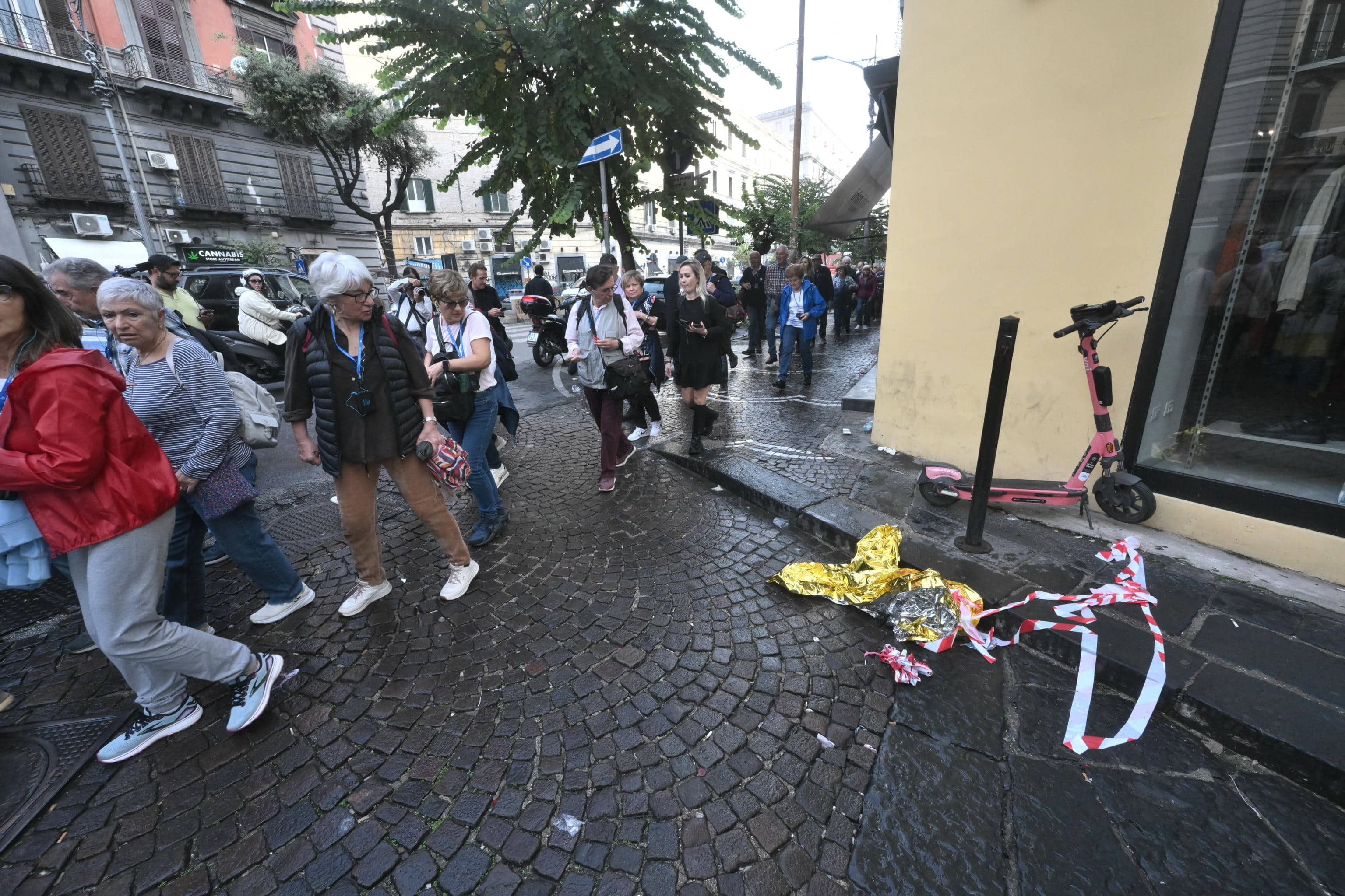 People passing over the scene where a 15-year-old boy was shot dead last night in Corso Umberto in Naples, Italy, 24 October 2024.
ANSA/CIRO FUSCO