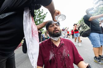 epa11494560 A medic (L) attempts to clean the eyes of a protester after US Capitol police pepper sprayed people gathered against the Israeli operations in Gaza and US weapons sales to Israel outside the US Capitol before Israeli Prime Minister Benjamin Netanyahu delivers an address to a joint session of Congress in Washington, DC, USA, 24 July 2024. Netanyahu's address to a joint meeting of the US Congress comes amid a close 2024 US presidential election cycle. Thousands of pro-Palestinian protesters were expected to gather near the US Capitol when Netanyahu becomes the first leader to address the US Congress four times.  EPA/JIM LO SCALZO