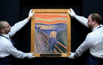 LONDON, ENGLAND - APRIL 12:  Gallery technicians at Sotheby's auction house adjust 'The Scream' by Edvard Munch on April 12, 2012 in London, England. The iconic painting is on public exhibition in London for the first time ahead of its auction in the 'Impressionist and Modern Art Evening Sale' at Sotheby’s New York on May 2, 2012 where it is expected to fetch in excess of 50 million GBP.  (Photo by Oli Scarff/Getty Images)