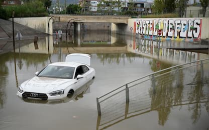A flooded car is pictured in the Barcelona suburbs of Castelldefels on November 4, 2024 as torrential rain struck Catalonia. Spain dreads more flood deaths as rain pounds Catalonia, where residents received telephone alerts urging the utmost caution, following deadly flooding that left 217 dead, almost all in the eastern Valencia region. (Photo by Josep LAGO / AFP)