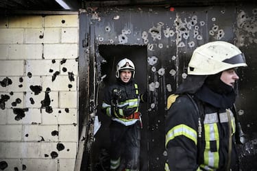Firefighters extinguish a fire on a house after shelling on the 17th day of the Russian invasion of Ukraine in Kyiv on March 12, 2022. - Russian forces are positioned around Kiev on March 12, 2022 and are "blocking" Mariupol, where thousands of people are suffering a devastating siege, in southern Ukraine, a country that has been bombed for more than two weeks. (Photo by Aris Messinis / AFP) (Photo by ARIS MESSINIS/AFP via Getty Images)