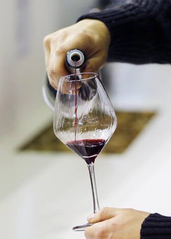 epa04098925 A glass is filled with red wine for a wine tasting at the Vinisud wine fair in Montpellier, France, 24 February 2014. Vinisud is the biggest Mediterranean wine fair where international merchants meet.
This exhibition showcases Mediterranean wines representing more than half of world production, according to the International Organisation of Vine and Wine (OIV).  EPA/GUILLAUME HORCAJUELO