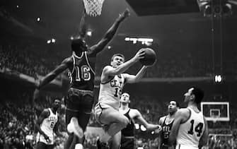 Tommy Heinsohn of the Celtic's, breaks past Al Attles of the Warriors, #16, to lay-up for a basket in the 1st quarter playoff.