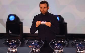 epa11137541 Spanish player Juan Mata holds up a slip of paper carrying the name Italy during the UEFA Nations League 2024/25 League Phase Draw at Maison De La Mutualite in Paris, France, 08 February 2024.  EPA/Mohammed Badra
