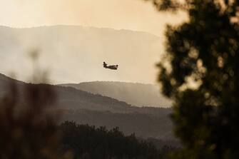 A Canadair firefighting aircraft flies over a wildfire near the National Park of Dadia, Alexandroupolis, Greece, on Monday, Aug. 28, 2023. With more than 72,000 hectares burnt, the Alexandroupolis wildfire in Evros is the largest on record in the EU. Photographer: Konstantinos Tsakalidis/Bloomberg via Getty Images