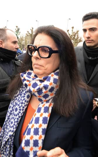 Francoise Bettencourt Meyers (L), daughter of France's richest woman, L'Oreal heiress Liliane Bettencourt, and her son Jean-Victor (R) leave a Justice court in Bordeaux, on January 26, 2015, after the suspension of the audience on the first day of the trial of ten people close to Bettencourt. The ten people are charged with exploiting the frail L'Oreal heiress in an explosive drama that began with a family feud and put a president in the court's crosshairs. The trial  began with the revelation that one of the accused, a former nurse of Bettencourt, had tried to kill himself on the eve of his appearance.
AFP PHOTO / MEHDI FEDOUACH        (Photo credit should read MEHDI FEDOUACH/AFP via Getty Images)