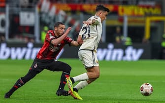 Paulo Dybala of AS Roma competes for the ball with Ismael Bennacer of AC Milan during UEFA Europa League 2023/24 Quarter Finals - 1st  leg football match between AC Milan and AS Roma at San Siro Stadium, Milan, Italy on April 11, 2024