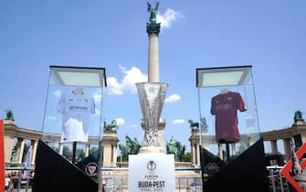 General view of Sevilla and Roma replica shirts with the trophy in Heroes' Square ahead of the UEFA Europa League Final at the Puskas Arena, Budapest. Picture date: Wednesday May 31, 2023.
