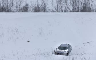An abandoned car sits in a ditch by a highway as a blizzard moves through Iowa on January 12, 2024. Photo by Julia Nikhinson/ABACAPRESS.COM