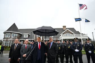 Former US President Donald Trump speaks to the press after attending the wake for New York Police Department (NYPD) Officer Jonathan Diller in Massapequa, Long Island, New York, on March 28, 2024. Diller was part of the NYPD's Critical Response Team when he was gunned down during a traffic stop in Queens on the night of March 25. (Photo by ANGELA WEISS / AFP) (Photo by ANGELA WEISS/AFP via Getty Images)