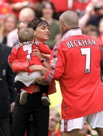 Manchester United's David Beckham (r) with wife Victoria and son Brooklyn  (Photo by Steve Mitchell/EMPICS via Getty Images)
