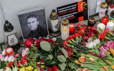 WARSAW, POLAND - 2024/02/24: Flowers, candles, and a portrait of Alexei Navalny, who died in prison, are placed near the walls of the Russian Embassy in Warsaw during the rally dedicated to the second anniversary of the full-scale invasion of Russia into Ukraine. Poland is a country that, in the first days of the full-scale invasion of Russia into Ukraine on February 24, 2022, accepted the largest number of refugees from Ukraine. On the second anniversary of the full-scale invasion, several thousands of people participated in the rally near the Embassy of the Russian Federation in Warsaw. (Photo by Volha Shukaila/SOPA Images/LightRocket via Getty Images)