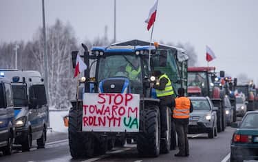 A banner reading "Stop agricultural products from UA" is seen on February 9, 2024 as farmers with tractors block the access to the Polish-Ukrainian border crossing in Dorohusk, eastern Poland, during a farmers' protest across the country against EU politics and Ukrainian agricultural products allowed on EU market at low prices. (Photo by Wojtek Radwanski / AFP) (Photo by WOJTEK RADWANSKI/AFP via Getty Images)