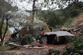 epa11130067 A vehicle is buried in a collapsed garage and house that moved off its  foundation down a hill as a powerful atmospheric river storm hits Southern California in Beverly Hills, California USA, 05 February 2024. Los Angeles Mayor Karen Bass declared a state of emergency in the area as flooding and mudslides overwhelmed California.  EPA/ALLISON DINNER