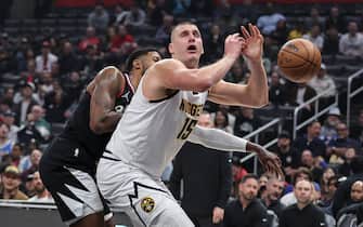 LOS ANGELES, CALIFORNIA - DECEMBER 06: Nikola Jokic #15 of the Denver Nuggets reacts as he is blocked by Paul George #13 of the Los Angeles Clippers during a game at Crypto.com Arena on December 06, 2023 in Los Angeles, California. NOTE TO USER: User expressly acknowledges and agrees that, by downloading and or using this photograph, User is consenting to the terms and conditions of the Getty Images License Agreement. (Photo by Michael Owens/Getty Images)