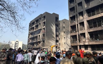 epa12171109 People gather at the site of a plane crash near Sardar Vallabhbhai Patel International Airport in Ahmedabad, Gujarat, western India, 12 June 2025. Air India flight AI171, bound for London carrying 242 passengers and crew members on board a Boeing 787-8 aircraft, crashed minutes after take-off in the Meghaninagar area of Ahmedabad.  EPA/SIDDHARAJ SOLANKI