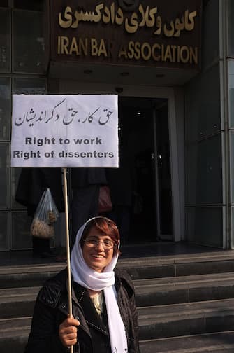 TEHRAN, IRAN - DECEMBER 14, 2014: Human rights lawyer Nasrin Sotoudeh photographed while holding a banner demanding her rights to work outside the bar association during her daily sit-in protesting the decision of the authorities to ban her from law practice on December 14, 2014 in Tehran, Iran. Nasrin Sotoudeh is a human rights lawyer who has represented imprisoned Iranian opposition activists and politicians following the disputed June 2009 Iranian presidential elections as well as prisoners sentenced to death for crimes committed when they were minors. Sotoudeh was arrested in September 2010 on charges of spreading propaganda and conspiring to harm state security and was imprisoned in solitary confinement in Evin Prison. In January 2011, Iranian authorities sentenced Sotoudeh to 11 years in prison, in addition to barring her from practicing law and from leaving the country for 20 years. An appeals court later reduced Sotoudeh's prison sentence to six years, and her ban from working as a lawyer to ten years. On 26 October 2012, Sotoudeh was announced as a co-winner of the Sakharov Prize of the European Parliament. She shared the award with Iranian film director Jafar Panahi. Sotoudeh was released on 18 September 2013 along with ten other political prisoners, including opposition leader Mohsen Aminzadeh, days before an address by Iranian President Hassan Rouhani to the United Nations. No explanation was given for her early release. (Photo by Kaveh Kazemi/Getty Images)