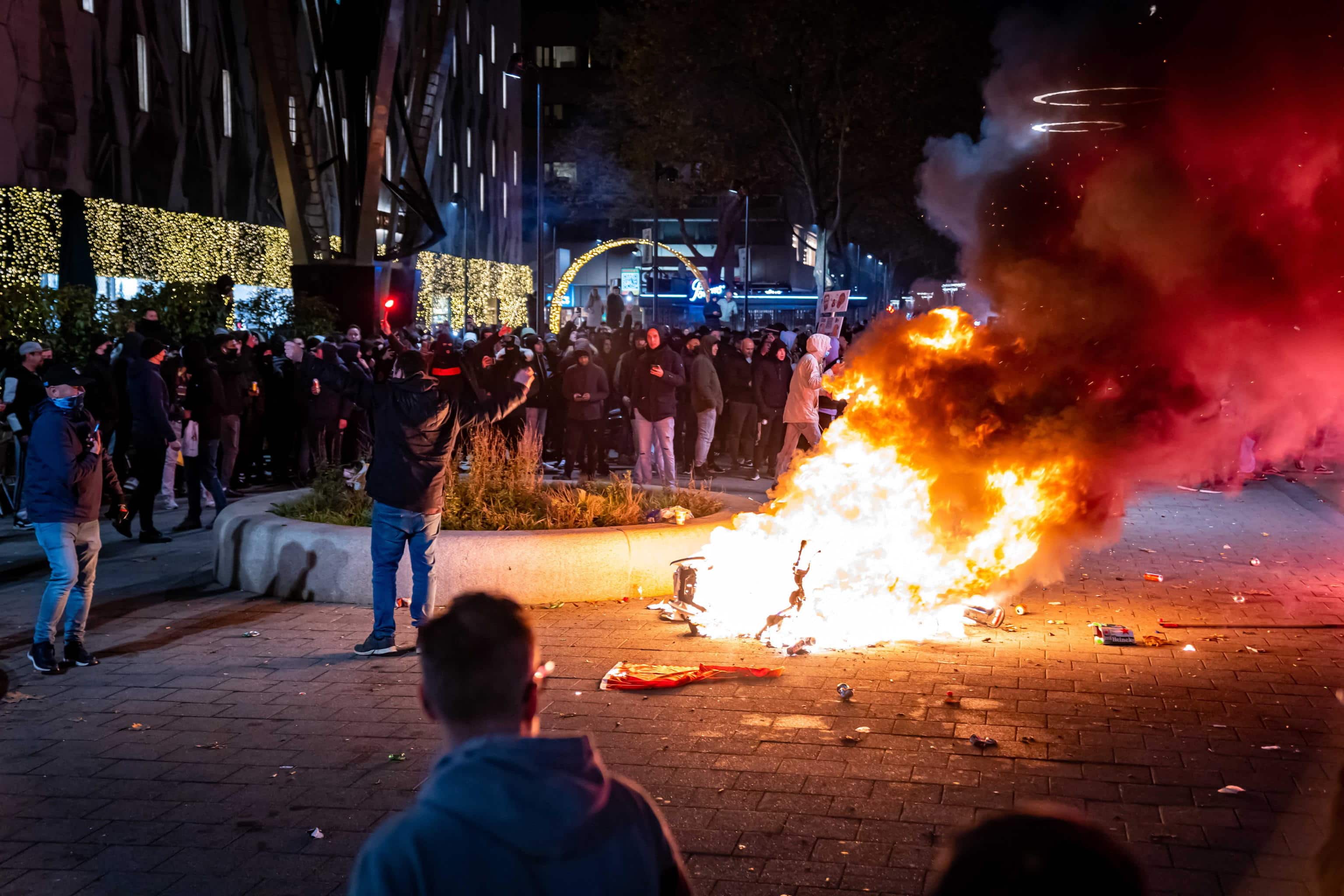 epa09592757  A scooter set on fire during a protest against the 2G policy in Coolsingel, Rotterdam, Netherlands, 19 November 2021. Hundreds of demonstrators have gathered to protest against the tightened coronavirus measures.  EPA/Killian Lindenburg