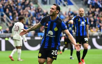 Inter Milan's Turkish midfielder #20 Hakan Calhanoglu celebrates after scoring  his team first goal during the Italian Serie A football match between Inter Milan and Torino at the San Siro Stadium in Milan,  on April 28, 2024. Inter clinched their 20th Scudetto with a 2-1 victory over AC Milan on April 22, 2024. (Photo by Piero CRUCIATTI / AFP) (Photo by PIERO CRUCIATTI/AFP via Getty Images)