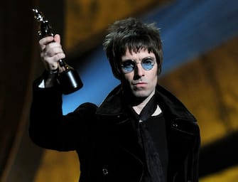 LONDON, ENGLAND - FEBRUARY 16:  Liam Gallagher accepts Oasis' award for 'Best Album of 30 Years' on stage at The Brit Awards 2010 at Earls Court on February 16, 2010 in London, England.  (Photo by Gareth Cattermole/Getty Images)