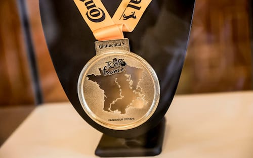 epa12121725 A Tour de France 2025 stage winner's medal on display during the press conference to celebrate the 50th anniversary of the first Tour de France finish on the Champs-Elysees at the Paris City Hall, France, 21 May 2025. The last stage of the Tour de France 2025 will take the streets of Montmatre as was already the case during the Paris 2024 Olympic Games. The Tour de France 2025 will take place from July 5 to 27, 2025.  EPA/Teresa Suarez
