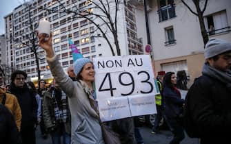 epa10530654 A woman holds a placard reading 'No to 49.3' during protests against the pension reform law in Paris, France, 18 March 2023. A thousands of people demonstrate in Paris after French Prime Minister Elisabeth Borne on 16 March had announced the use of article 49 paragraph 3 (49.3) of the Constitution of France to have the text on the controversial pension reform law to be definitively adopted without a vote.  EPA/TERESA SUAREZ
