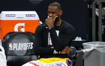 PHOENIX, ARIZONA - JUNE 01:  LeBron James #23 of the Los Angeles Lakers reacts on the bench during the second half in Game Five of the Western Conference first-round playoff series at Phoenix Suns Arena on June 01, 2021 in Phoenix, Arizona. NOTE TO USER: User expressly acknowledges and agrees that, by downloading and or using this photograph, User is consenting to the terms and conditions of the Getty Images License Agreement.  (Photo by Christian Petersen/Getty Images)