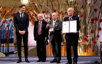 (L-R) The Chairman of the Nobel Committee Jørgen Watne Frydnes and the representatives of the organization Nihon Hidankyo, (2ndL-R) Terumi Tanaka, Shigemitsu Tanaka and Toshiyuki Mimaki receive their Nobel Peace Prize award during the ceremony at the Oslo City Hall in Oslo, Norway on December 10, 2024. the Nobel Peace Prize on December 10, 2024 but, after years of anti-nuclear campaigning and showing the world their scars, they still retain the painful memories of the discrimination they have faced. (Photo by Heiko Junge / NTB / AFP) / Norway OUT