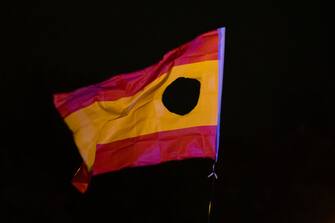 MADRID, SPAIN - 2023/11/09: A Spanish flag with the coat of arms deliberately cut out is seen during a protest in front of socialist party PSOE headquarters in Ferraz street for the seventh consecutive day of protests following the recent agreement between PSOE and Junts party, which unfolded today in Brussels. Thousands responded to a call by far right groups to protest the approval of an amnesty for Catalan separatist leaders which is included in the agreement and guarantees the investiture of the socialist candidate Pedro Sanchez. (Photo by Marcos del Mazo/LightRocket via Getty Images)